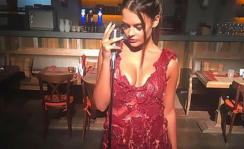 Model forced to wear dress made of RAW MEAT