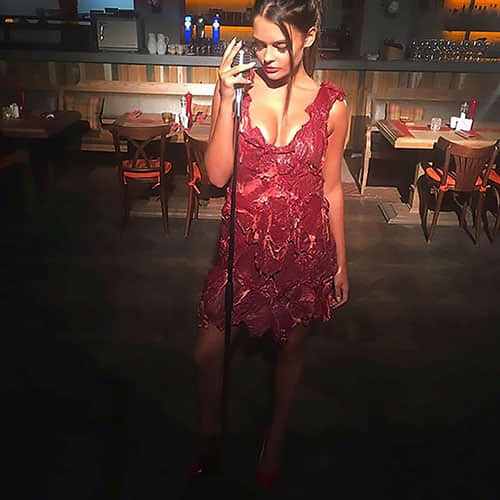 Model forced to wear dress made of RAW MEAT