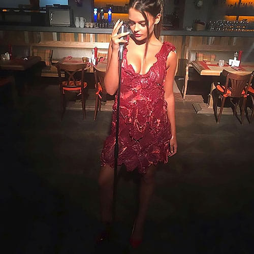 Model forced to wear dress made of RAW MEAT