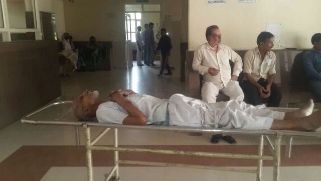Was lying on a stretcher to an ambulance waiting an hour old