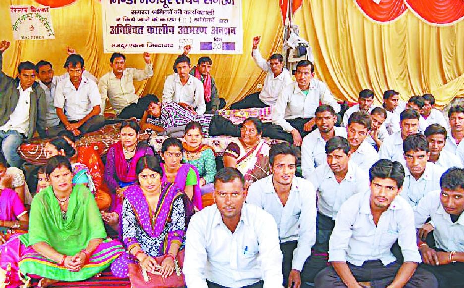 ALC Minda workers outside the office, sitting on an indefinite fast.