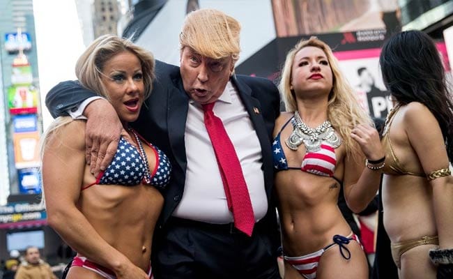 Bikini-Clad Models Surround Fake Donald Trump In New York City Stunt