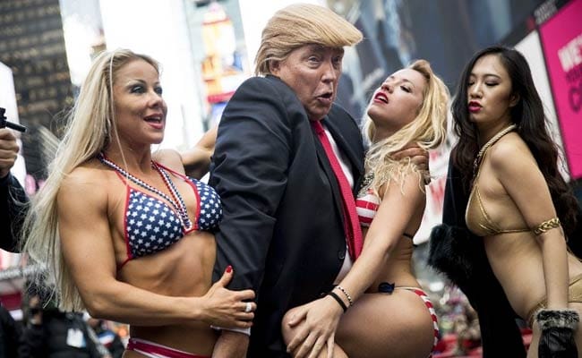 Bikini-Clad Models Surround Fake Donald Trump In New York City Stunt