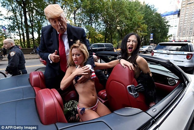 Bikini-Clad Models Surround Fake Donald Trump In New York City Stunt