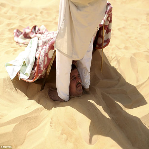 Egyptians bury themselves up to their necks for desert sand baths