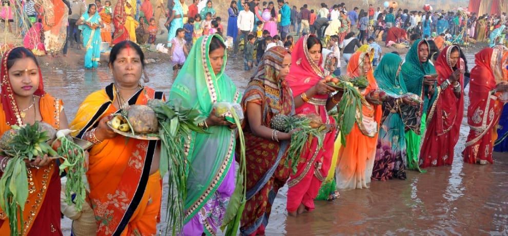 People who take vows to offer water to the setting sun descended Chhath Puja