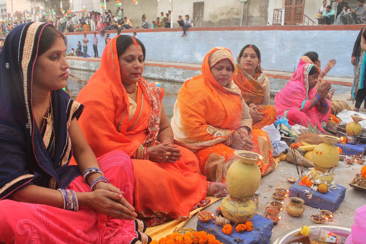 People who take vows of women offer water to the setting sun