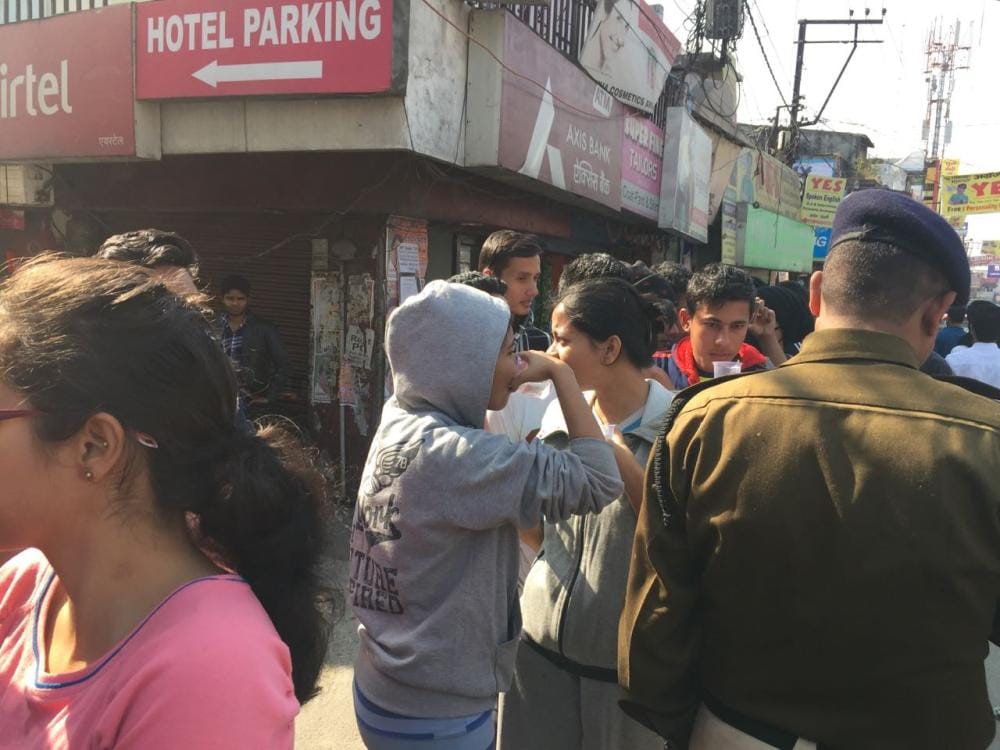 police bring water to people standing outside atm