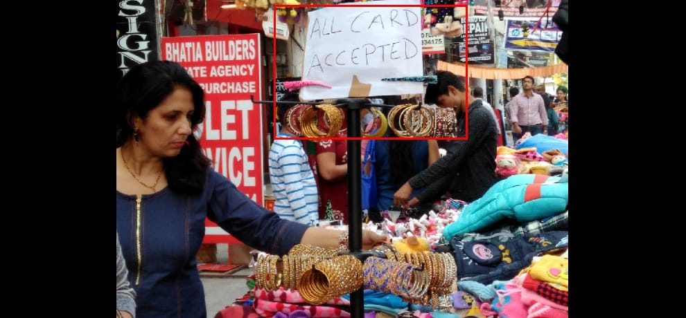 Demonetization: street vendors shaking hands with nearby retailers for card swapping facility