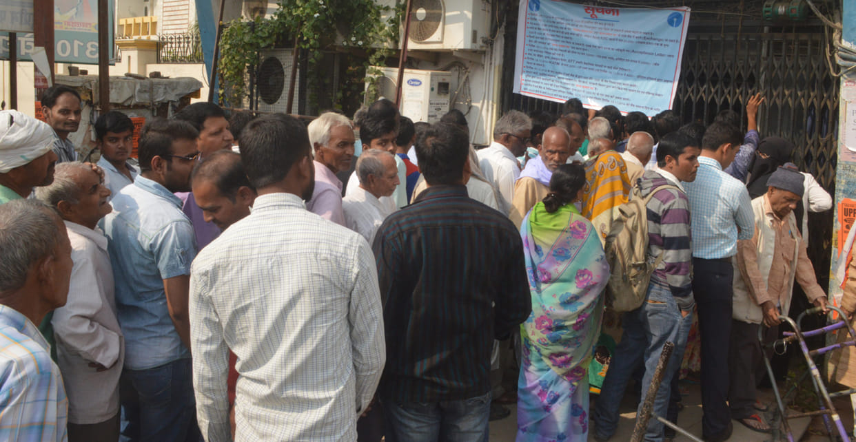 People stand in line for money, disappointed