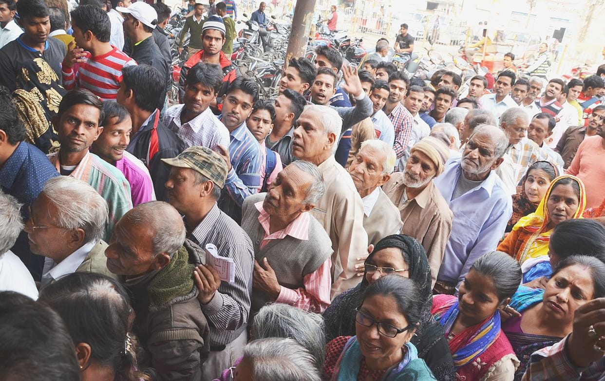 Elderly struggling in queue.