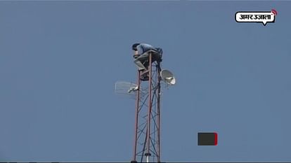FARMER CLIMBS ON TOWER TO PROTEST