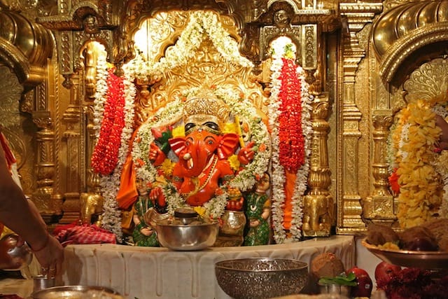 temple of india jewelry and coin in prasad