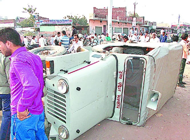 Farmers Jeep upturned, the jammed highway