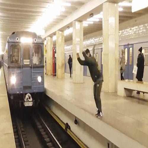 man jump across platform in front of speeding train