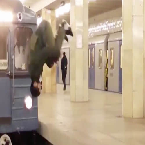 man jump across platform in front of speeding train