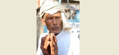 man standing in que to get cash for last rituals  din not got money