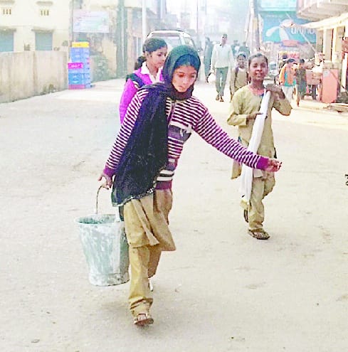 Buckets of water in place of the book in the hands of children