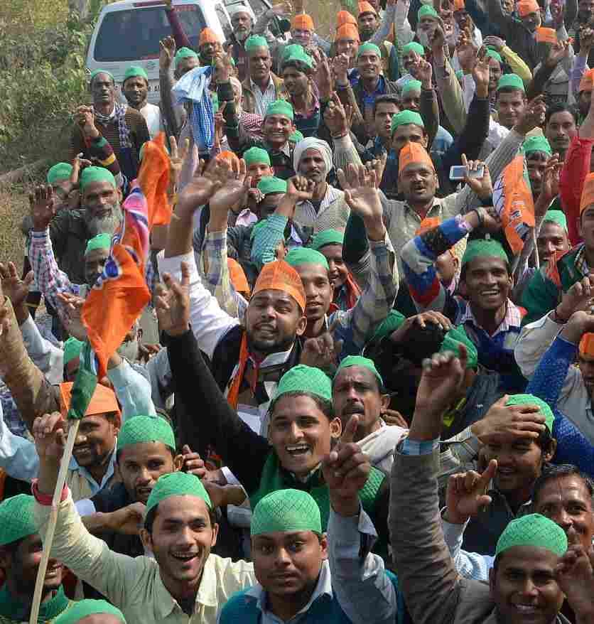 people rich in modi rally in green hat