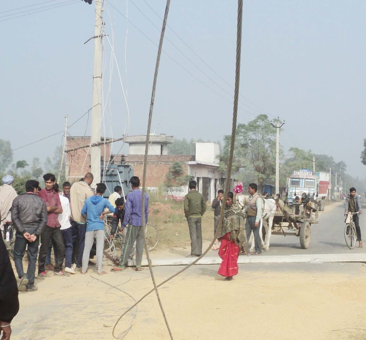 Overloaded electrical pole fell on the road dropped from the husk truck collision
