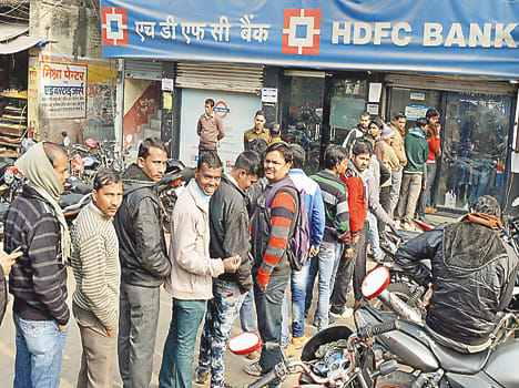 Grameen Bank, a crowd of people looking at the ATM