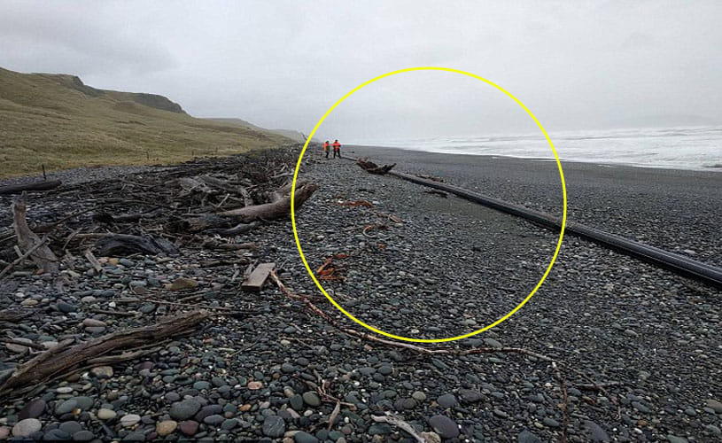 100 metre long pipe has washed up on a beach  