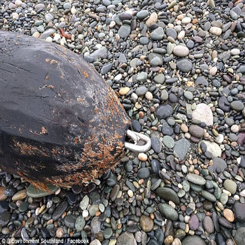 100 metre long pipe has washed up on a beach  