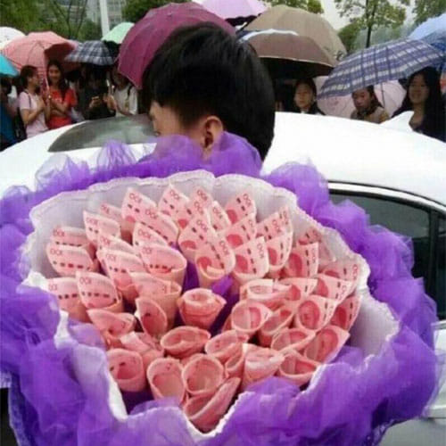 man proposes girlfriend with a bouquet made of currency