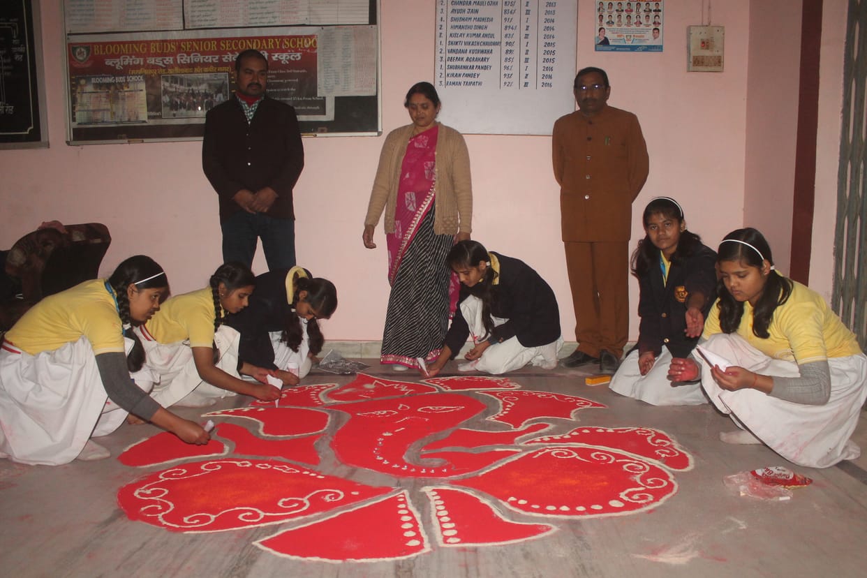 The detainee remains at the center of the rangoli 