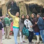 चर्च में बनी गौशाला के पास सेल्फी लेती युवतियां।