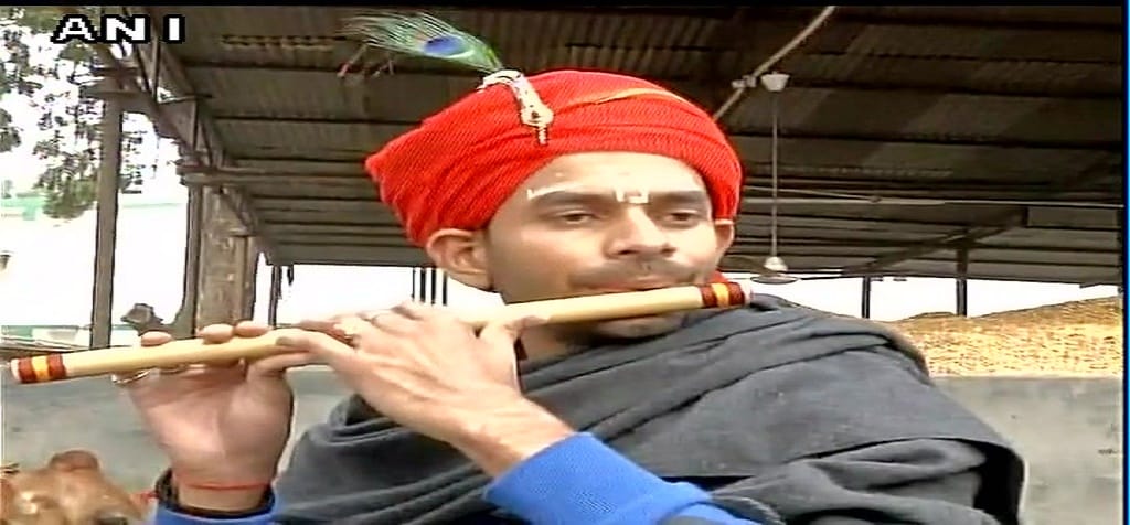 son of RJD Chief Lalu Yadav, Tej Pratap Yadav plays flute dressed as Krishna