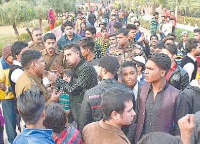 New Year woman, manipulating poles stick out fiercely, rumor of communal tension
