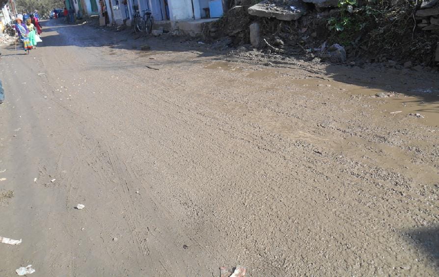 Sunny dirt road from the market, people upset