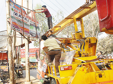 Cleaning campaign billboards and wall painting for the second day running