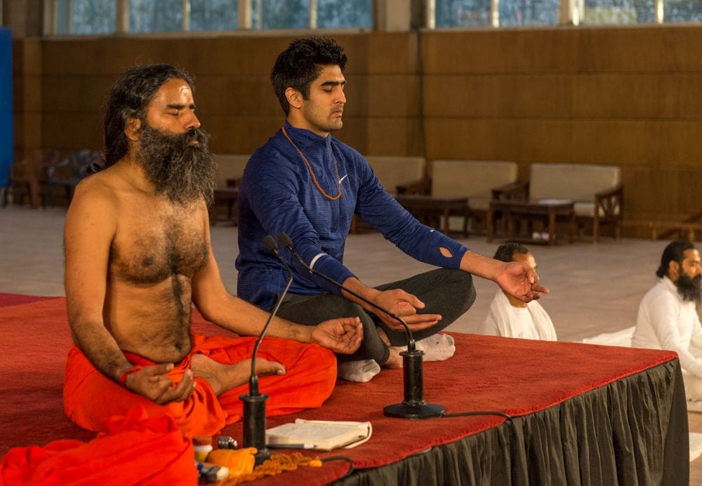boxer vijender doing yoga with baba ramdev