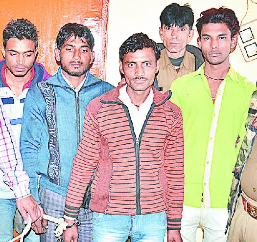Four members of the gang holding the bike thief
