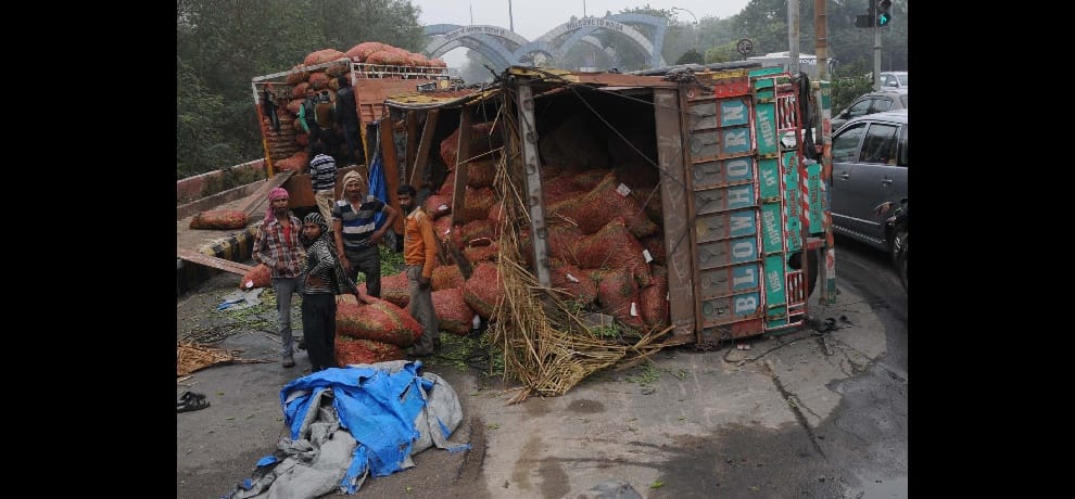 Two truck turned, climbed on the bus dividers, vegetables scattered on the road