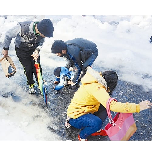 slipping and sliding on snow in queen of the hills shimla