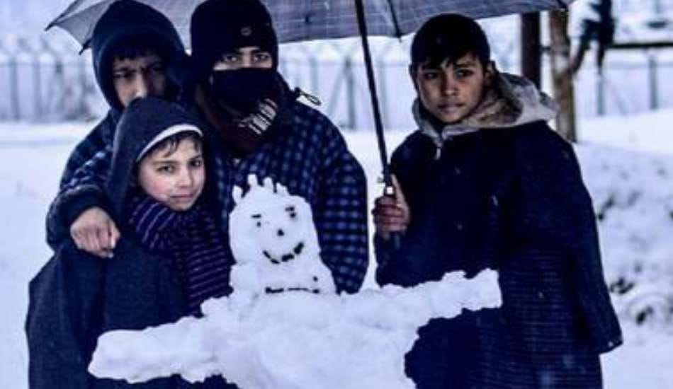 TOURISTS MAKING FUN WITH SNOWMAN IN KASHMIR