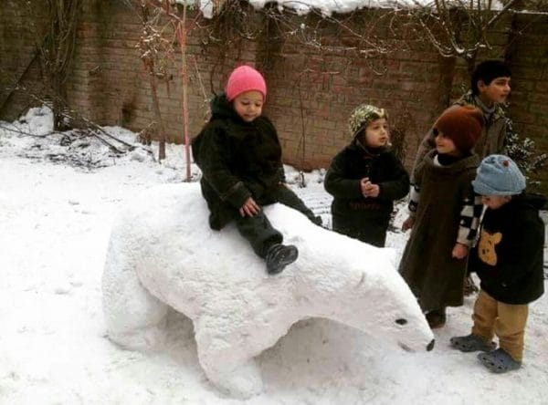 TOURISTS MAKING FUN WITH SNOWMAN IN KASHMIR