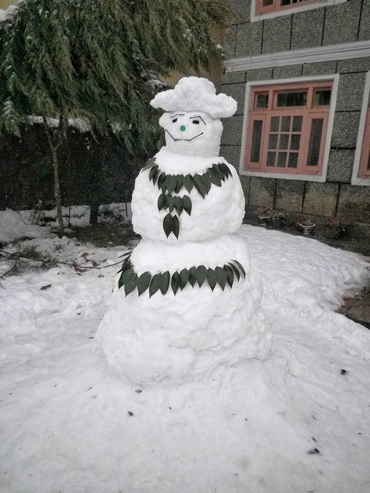 TOURISTS MAKING FUN WITH SNOWMAN IN KASHMIR