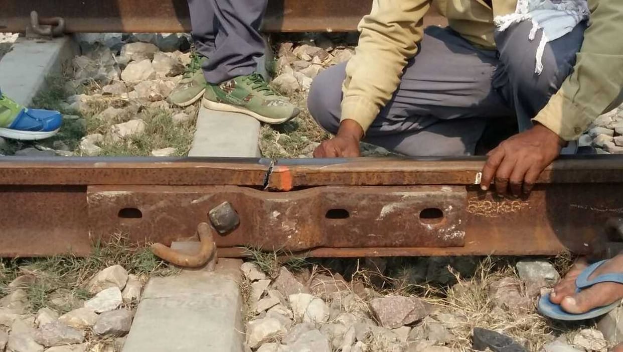 The train passing through the broken railing