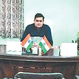 Nauchandi police inspector Scribe sits on a chair
