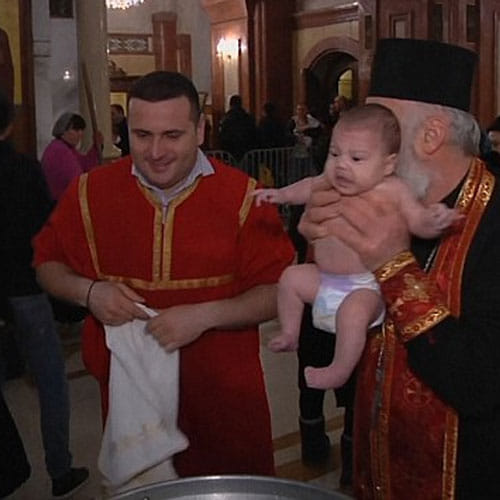 Patriarch of Church dunks babies roughly underwater