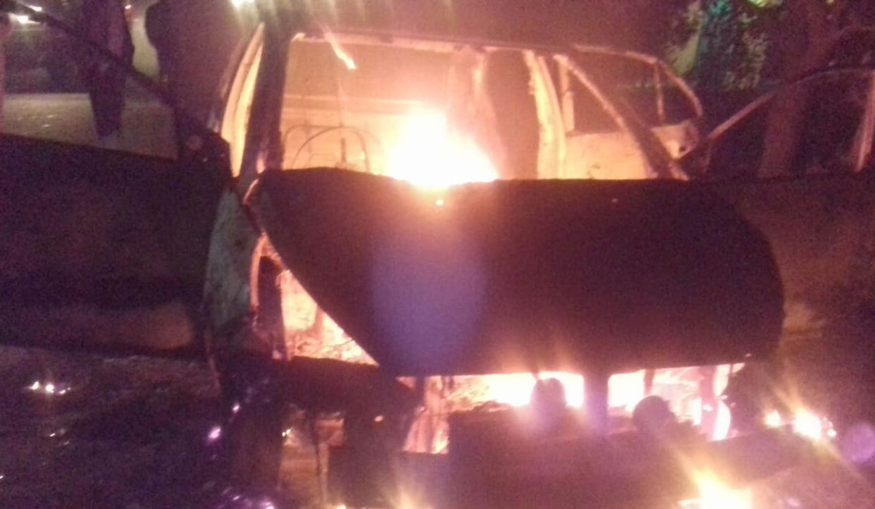 By flames burnt car