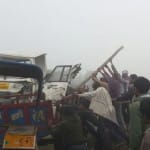मालवाहक गाड़ी को पटरी के पास से हटाते लोग