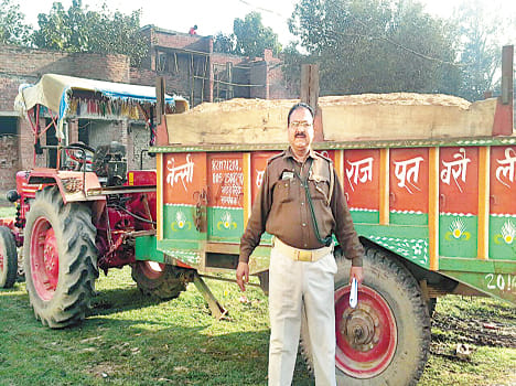 Murng laden tractor, holding rifles recovered