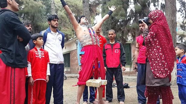 Fearless strongman lifts bricks with his EYELIDS while standing on nails.
