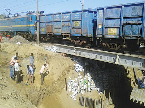 Clay filled bags attached to the safety of railway track
