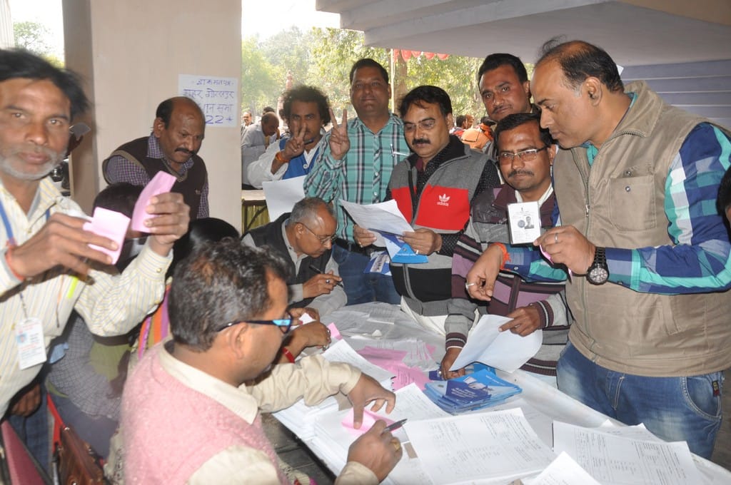 Employees doing eelction duty cast their vote